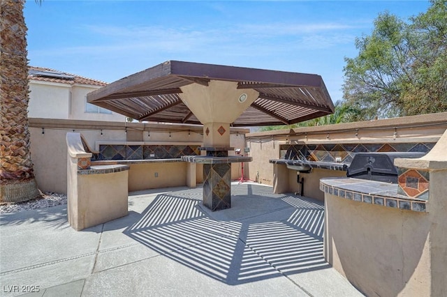 view of patio featuring area for grilling and exterior kitchen