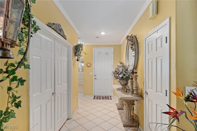 hall with light tile patterned flooring and ornamental molding