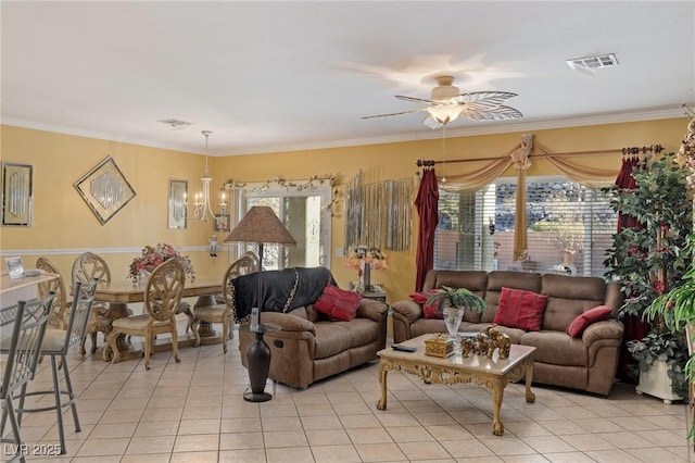 tiled living room with plenty of natural light, ceiling fan with notable chandelier, and crown molding