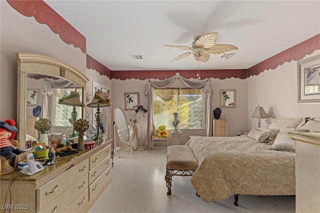 bedroom with ceiling fan and light hardwood / wood-style flooring