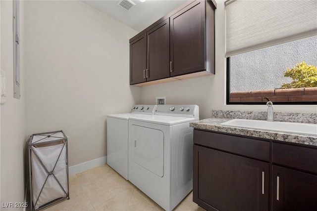 laundry room featuring cabinets, separate washer and dryer, and sink