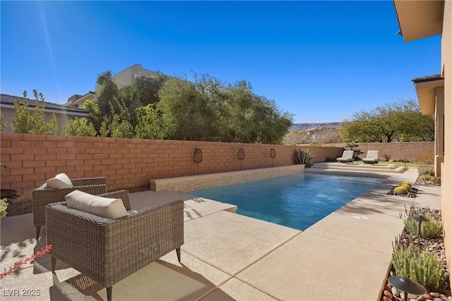 view of swimming pool featuring a patio area