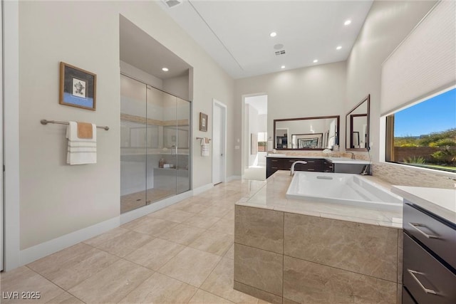 bathroom with shower with separate bathtub, vanity, and tile patterned flooring