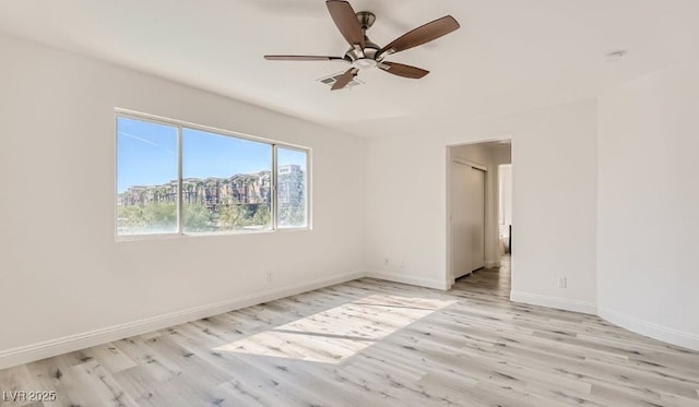 unfurnished room featuring ceiling fan and light wood-type flooring