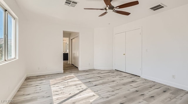 unfurnished bedroom featuring ceiling fan, light hardwood / wood-style flooring, and a closet