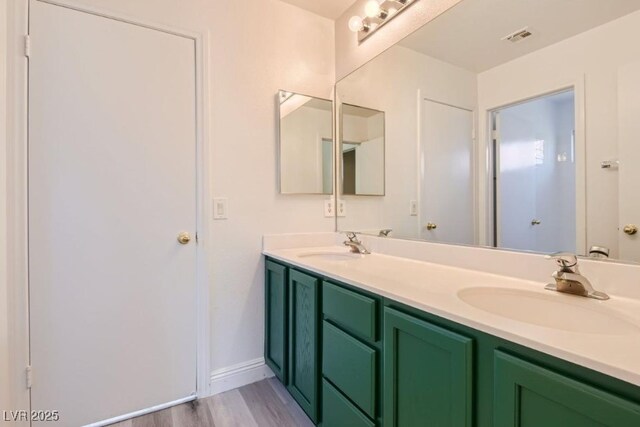 bathroom featuring hardwood / wood-style flooring and vanity