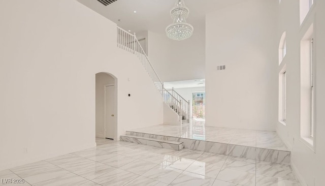 hall with a chandelier and a high ceiling