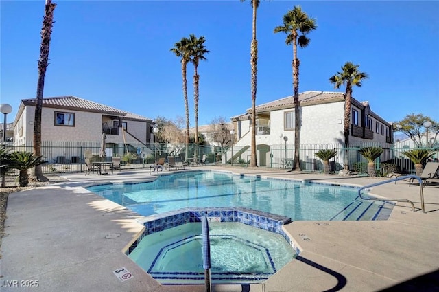 view of swimming pool with a patio and a hot tub