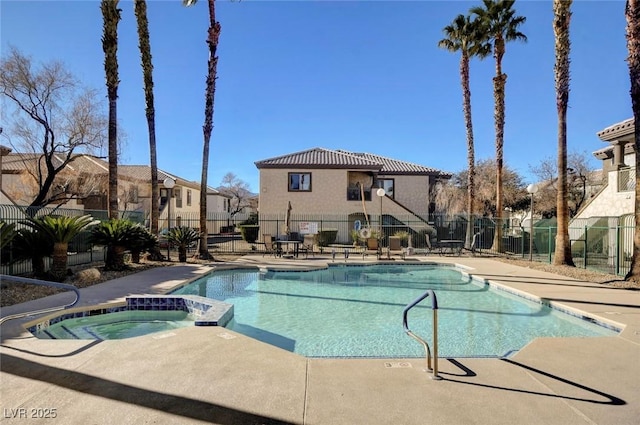 view of swimming pool with a community hot tub and a patio area