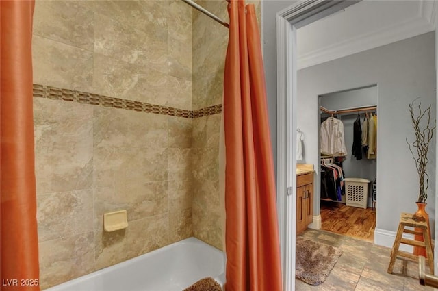 bathroom featuring vanity, ornamental molding, and shower / bath combo