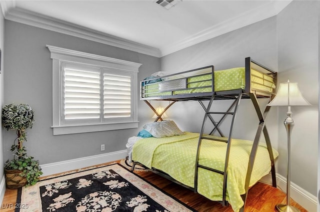 bedroom featuring crown molding and hardwood / wood-style flooring