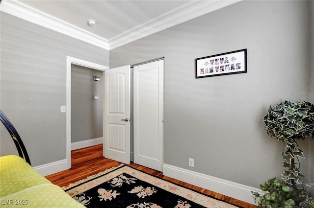 entrance foyer with wood-type flooring and ornamental molding