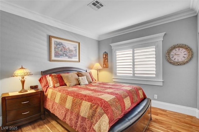 bedroom featuring ornamental molding and light hardwood / wood-style floors