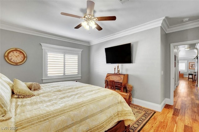 bedroom featuring light hardwood / wood-style flooring, ornamental molding, and ceiling fan