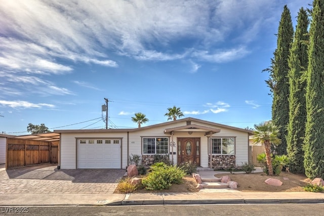 ranch-style home with a carport and a garage