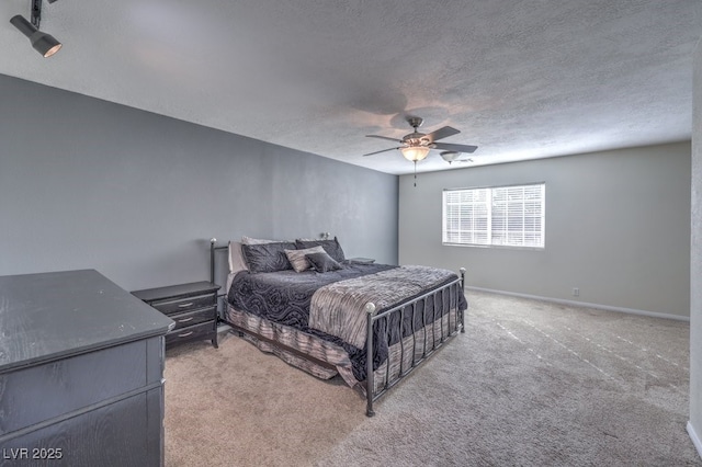 carpeted bedroom featuring a textured ceiling and ceiling fan