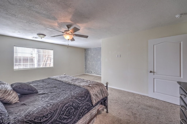 carpeted bedroom with ceiling fan and a textured ceiling