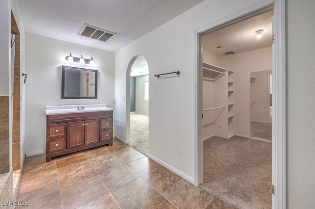 bathroom with a textured ceiling and vanity