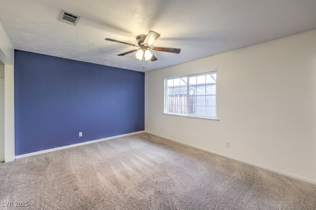 unfurnished room featuring carpet, a textured ceiling, and ceiling fan