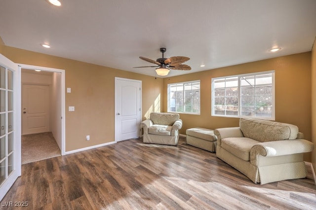 interior space featuring wood-type flooring and ceiling fan