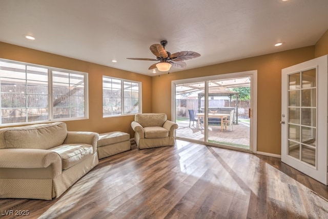 living room with wood-type flooring and ceiling fan