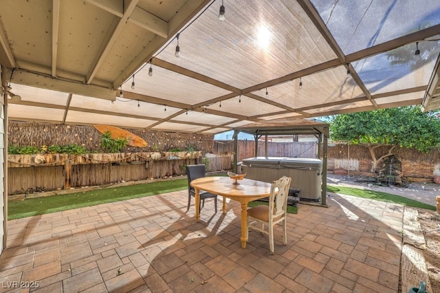 view of patio / terrace with a hot tub