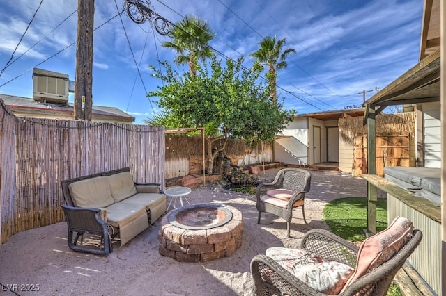 view of patio / terrace featuring a shed and a fire pit