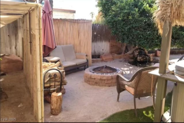 view of patio / terrace with an outdoor fire pit