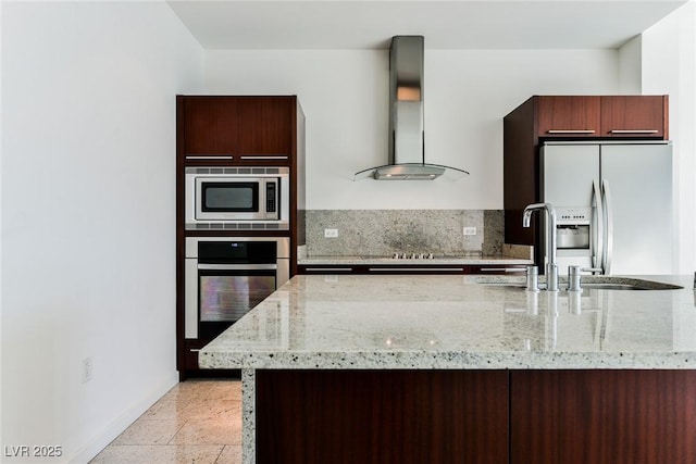 kitchen with exhaust hood, light stone counters, sink, and stainless steel appliances