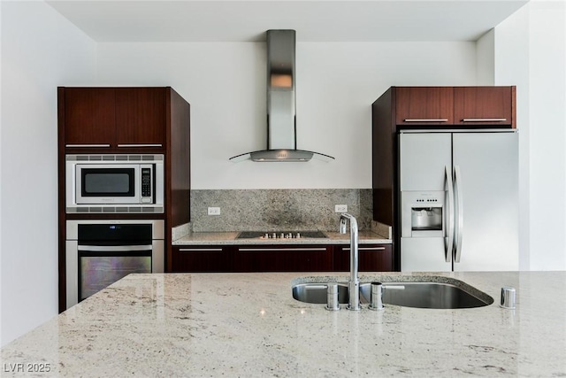 kitchen featuring backsplash, sink, light stone countertops, range hood, and stainless steel appliances