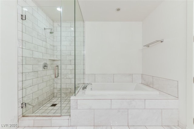 bathroom featuring tile patterned floors and independent shower and bath