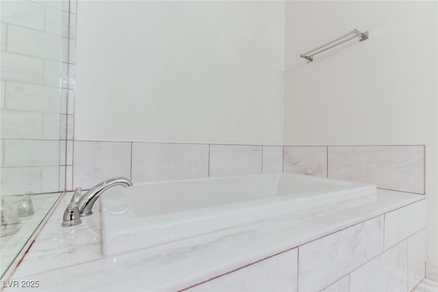 bathroom with a relaxing tiled tub