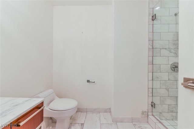 bathroom with vanity, a shower with shower door, and toilet