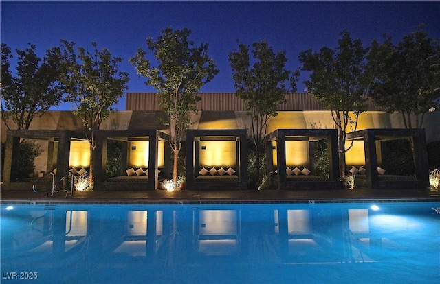 view of pool at night