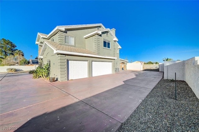 view of side of property with a garage