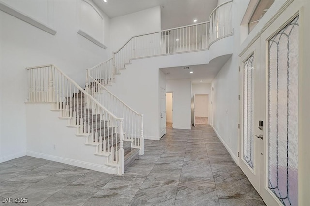 entryway featuring a towering ceiling