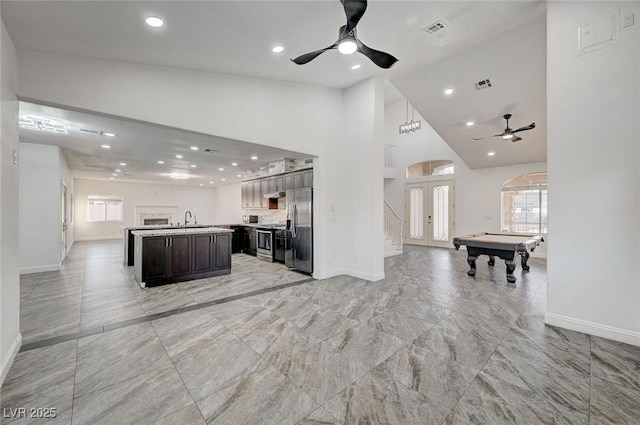 kitchen featuring french doors, sink, pool table, a kitchen island, and stainless steel appliances