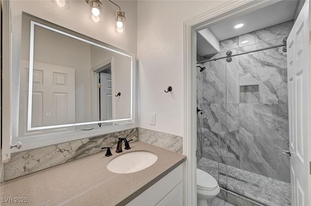 bathroom with toilet, an enclosed shower, and vanity