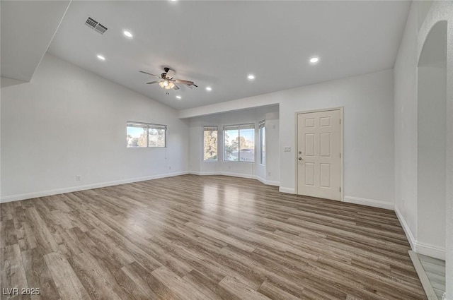 spare room featuring ceiling fan, light hardwood / wood-style flooring, and vaulted ceiling