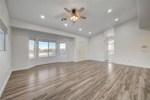 empty room with ceiling fan and light hardwood / wood-style floors