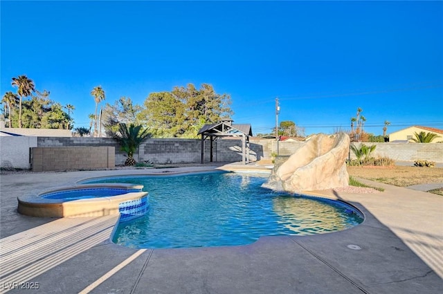 view of pool with an in ground hot tub and a patio