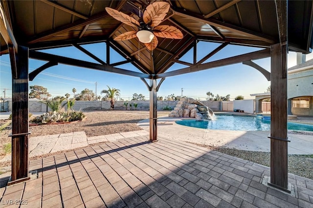 view of swimming pool featuring pool water feature, ceiling fan, a gazebo, and a patio