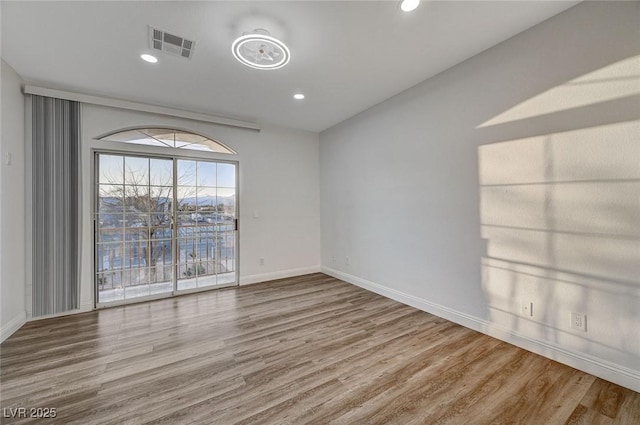 empty room with hardwood / wood-style flooring