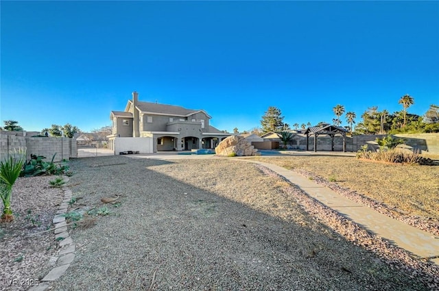 back of property with a gazebo