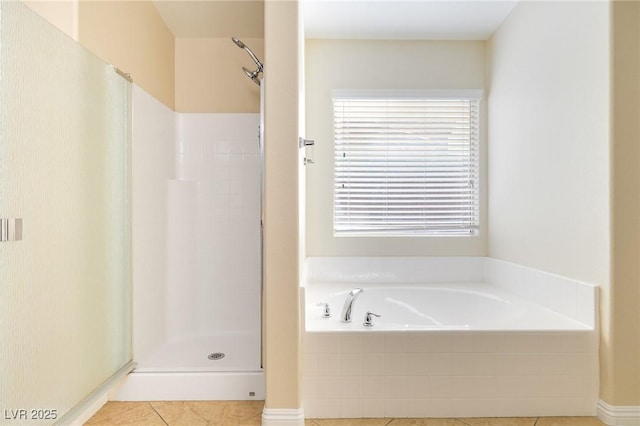 bathroom featuring plus walk in shower and tile patterned floors