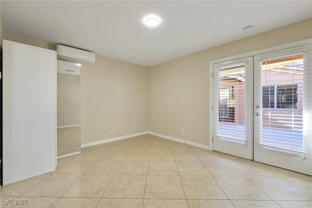 tiled spare room featuring french doors and a wall mounted air conditioner