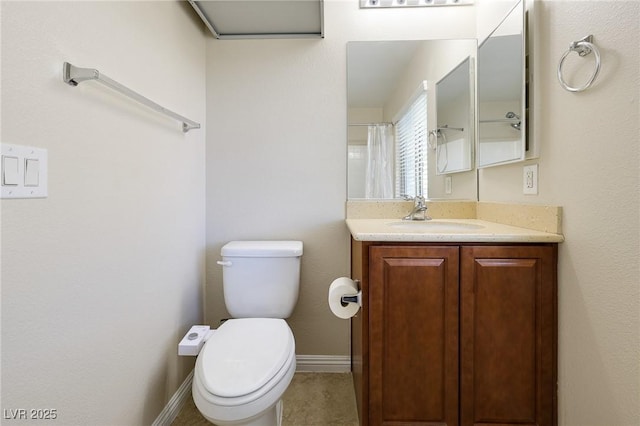 bathroom with toilet, vanity, and a shower with curtain