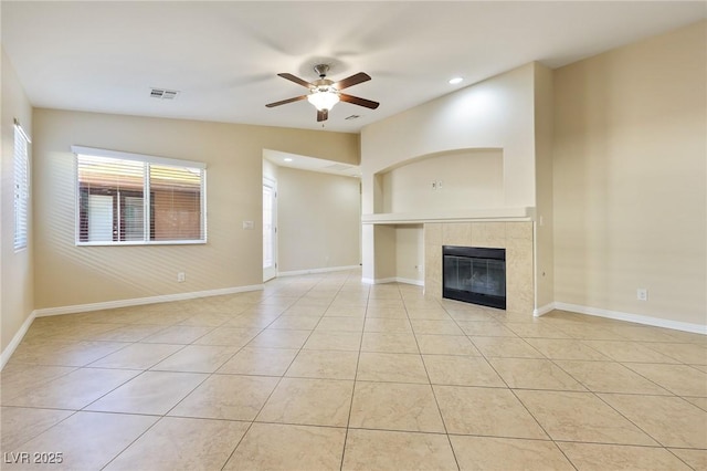 unfurnished living room featuring light tile patterned flooring, a fireplace, ceiling fan, and vaulted ceiling