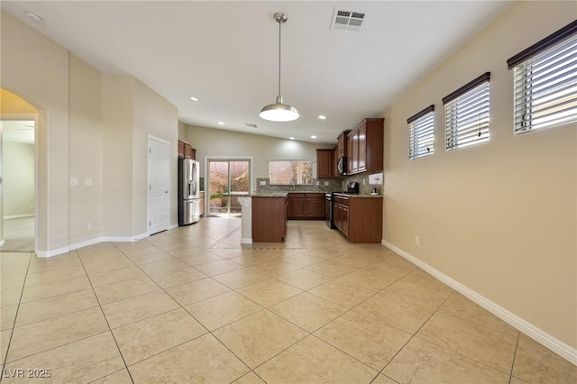 kitchen with pendant lighting, light tile patterned floors, lofted ceiling, backsplash, and appliances with stainless steel finishes