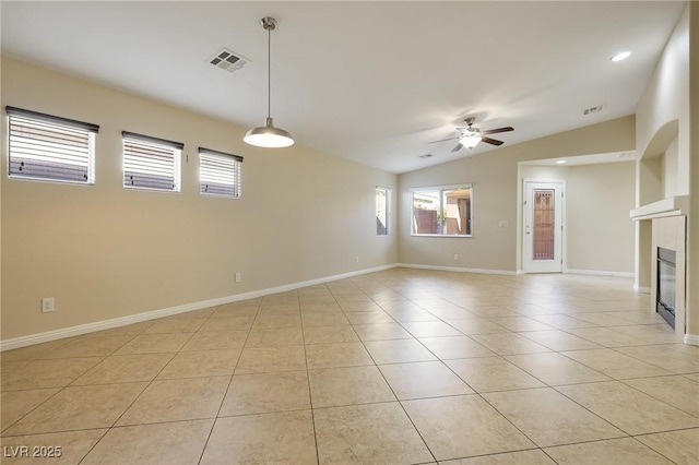 empty room with ceiling fan, light tile patterned flooring, and vaulted ceiling